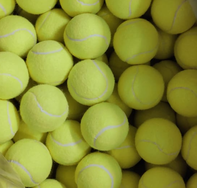 A plastic bag filled with Advanced Tennis Balls Bulk Order $0.49/ps - Bouncing 53 inch High in bulk.